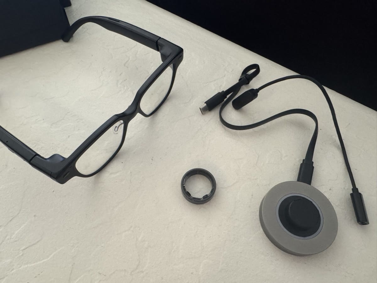 MIRA glasses next to the control ring and round charging dock